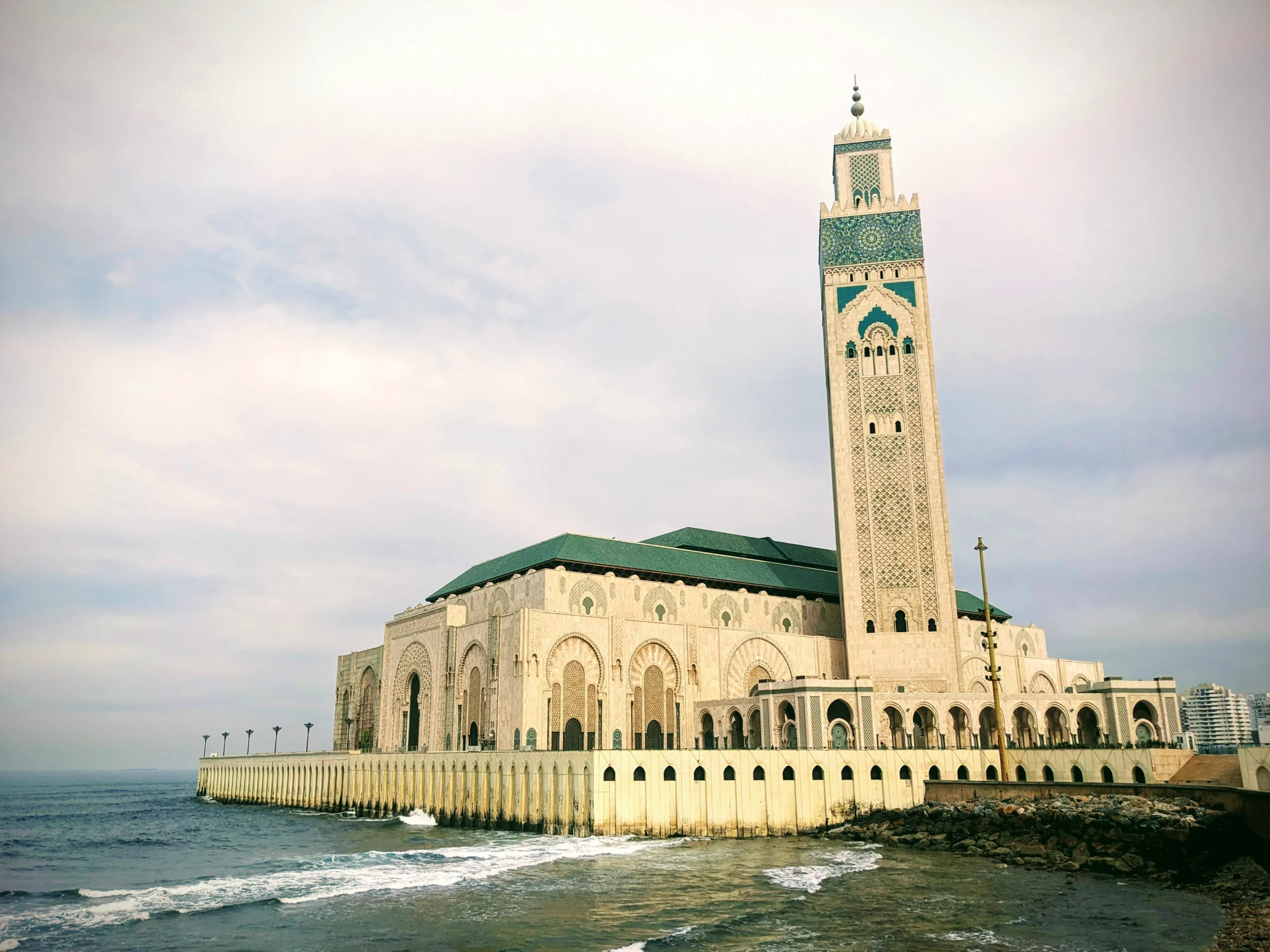 White Hassan II Mosque building by the ocean in Casablanca